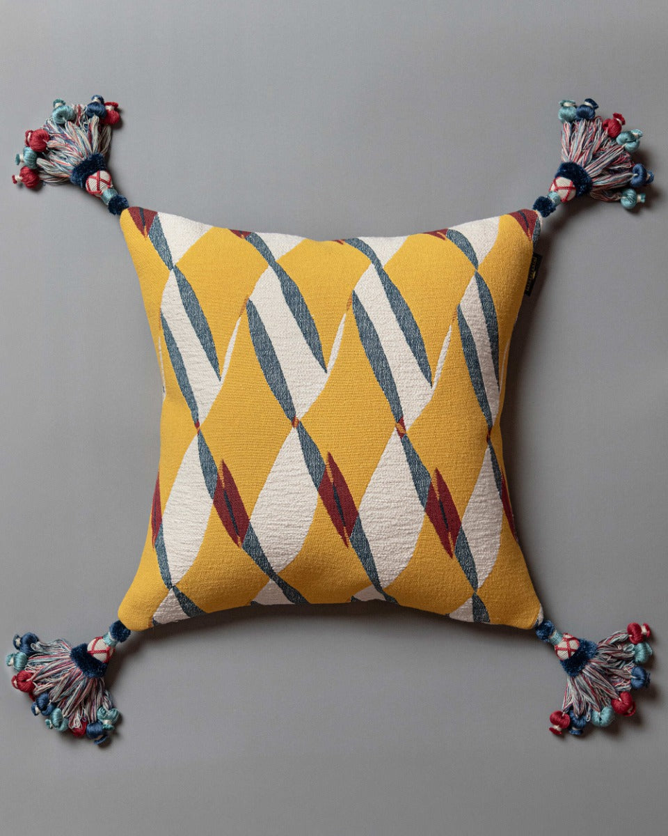 GLORIA cushion (LC40281) by Mind The Gap | LC40281 | TRANSYLVANIAN RHAPSODY | 50 x 50 cm / 20 x 20 in | Blue, White, Yellow, Red | Tasseled corners | Duck feather | 82% Cotton, 10% Polyamide, Other Fibers | Fabric Carolina | https://www.fabriccarolina.com/