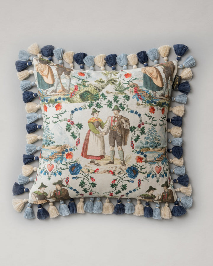 LANDHAUSMODE Cushion (LC40197) by Mind The Gap | LC40197 | TYROL APRES-SKI | 50 x 50 cm | Blue, White, Green, Red | Fringes all around | Duck feather | 56% Cotton, 44% Linen | Fabric Carolina | https://www.fabriccarolina.com/